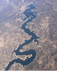 an aerial view of a lake from an airplane