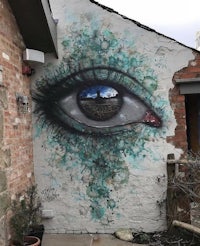 an eye painted on the side of a building