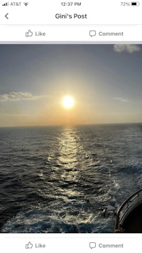 a picture of a cruise ship with a sunset in the background